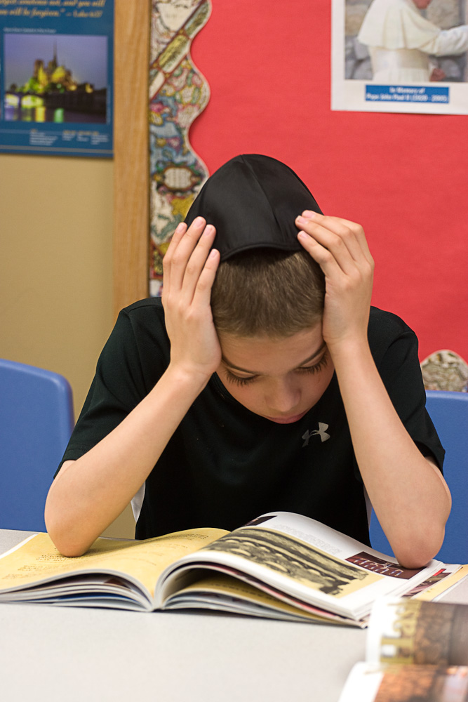 reading intently in Sunday school class